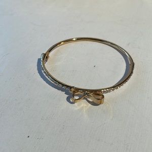 Kate spade gold plated love note bow & cz bracelet with hinge/magnet closure